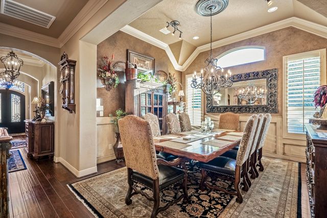 a view of a dining room with furniture and chandelier