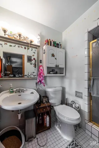 a bathroom with a toilet sink and mirror