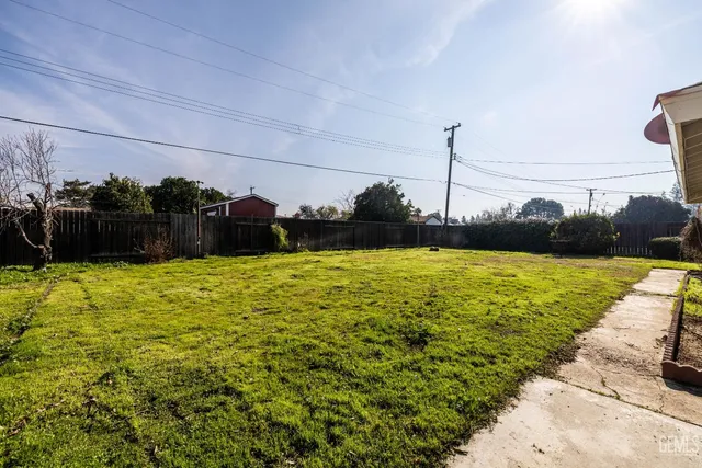 a view of a swimming pool with an outdoor seating and a yard