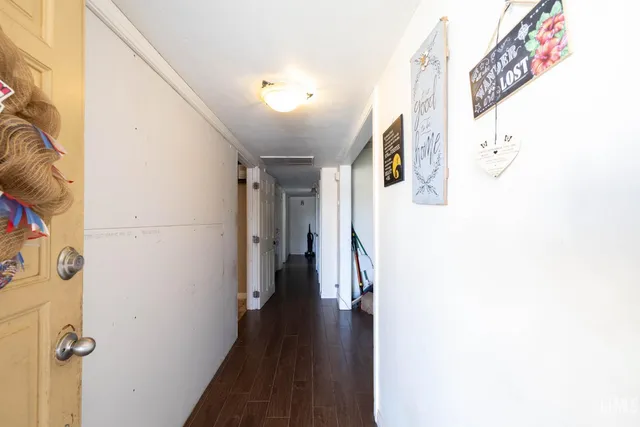 a view of a hallway with wooden floor