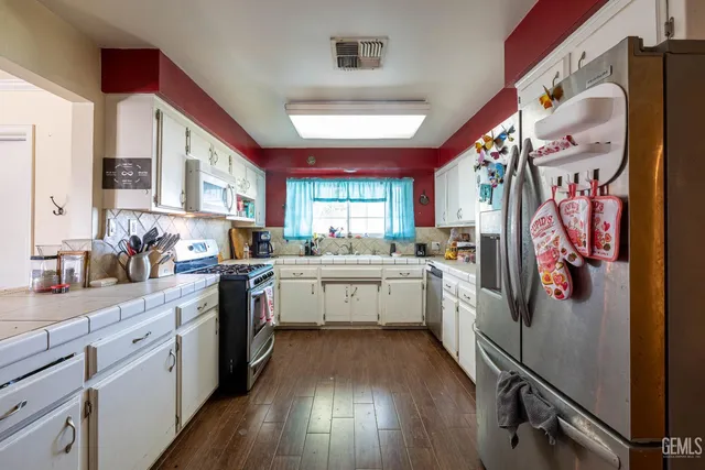 a kitchen with a white cabinets and white appliances