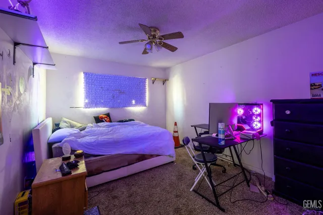 a bedroom with a bed a desk and chair