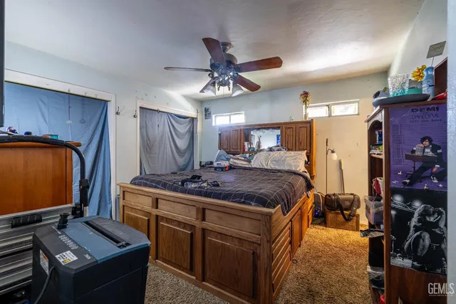 a bed room with a bed and a television