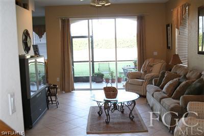 20244 Larino Loop Estero, FL 33928 - Photo 2 of 10 a living room with furniture and a floor to ceiling window