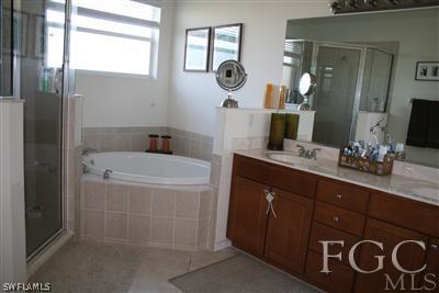 20244 Larino Loop Estero, FL 33928 - Photo 6 of 10 a bathroom with a bathtub sink and mirror