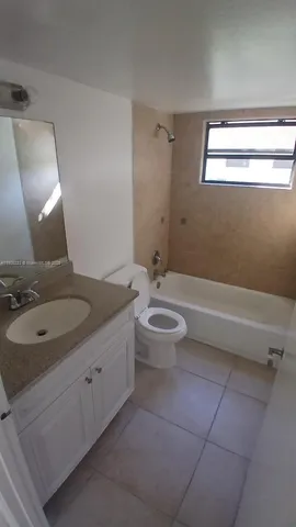a white bath tub sitting next to a toilet