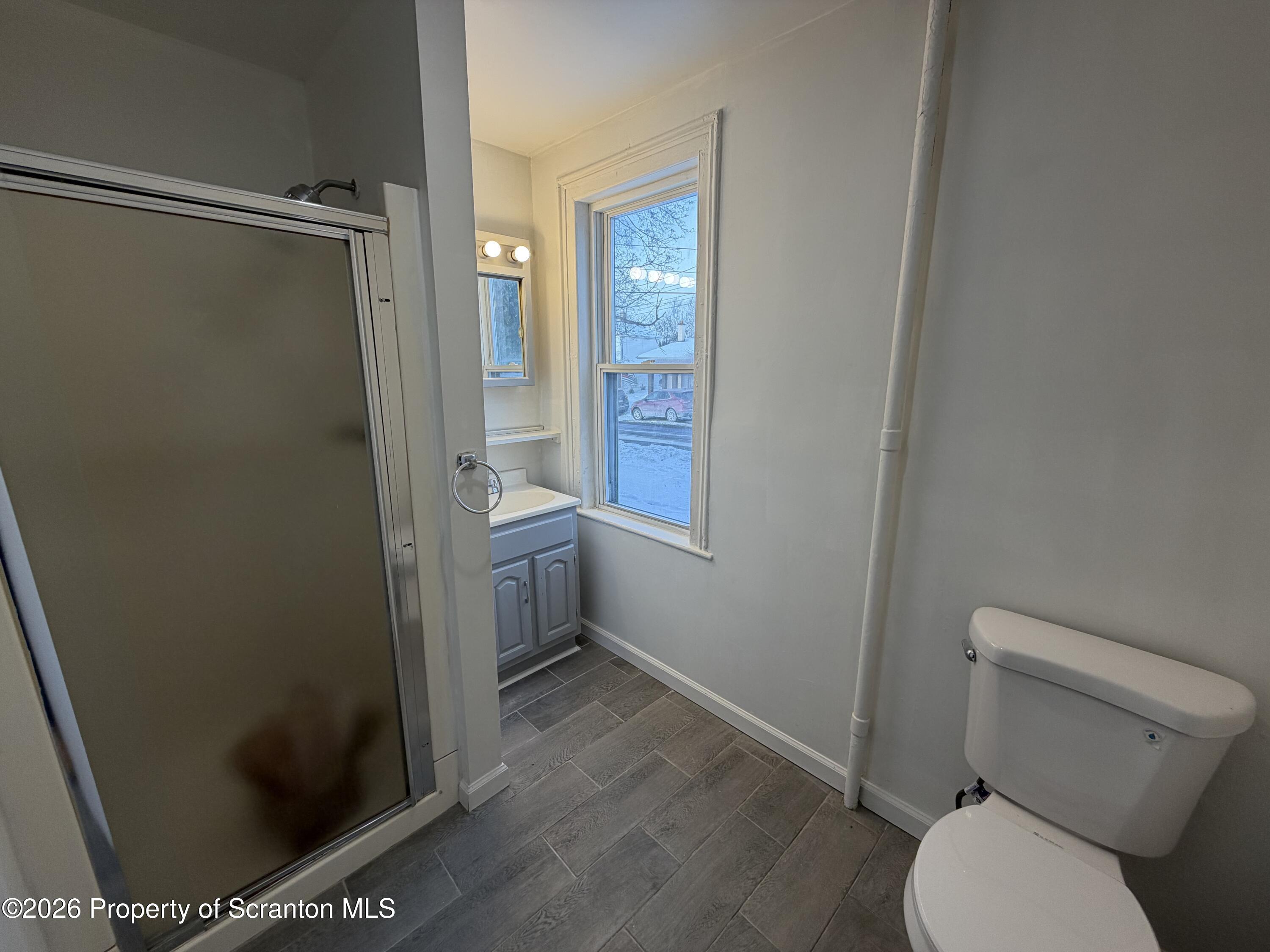 101 Clarkson Street, Unit 1 Jessup, PA 18434 - Photo 9 of 13 a bathroom with a toilet and a shower