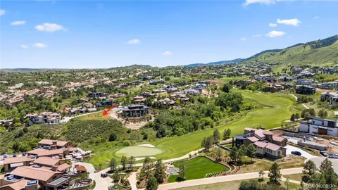 an aerial view of a residential houses with yard