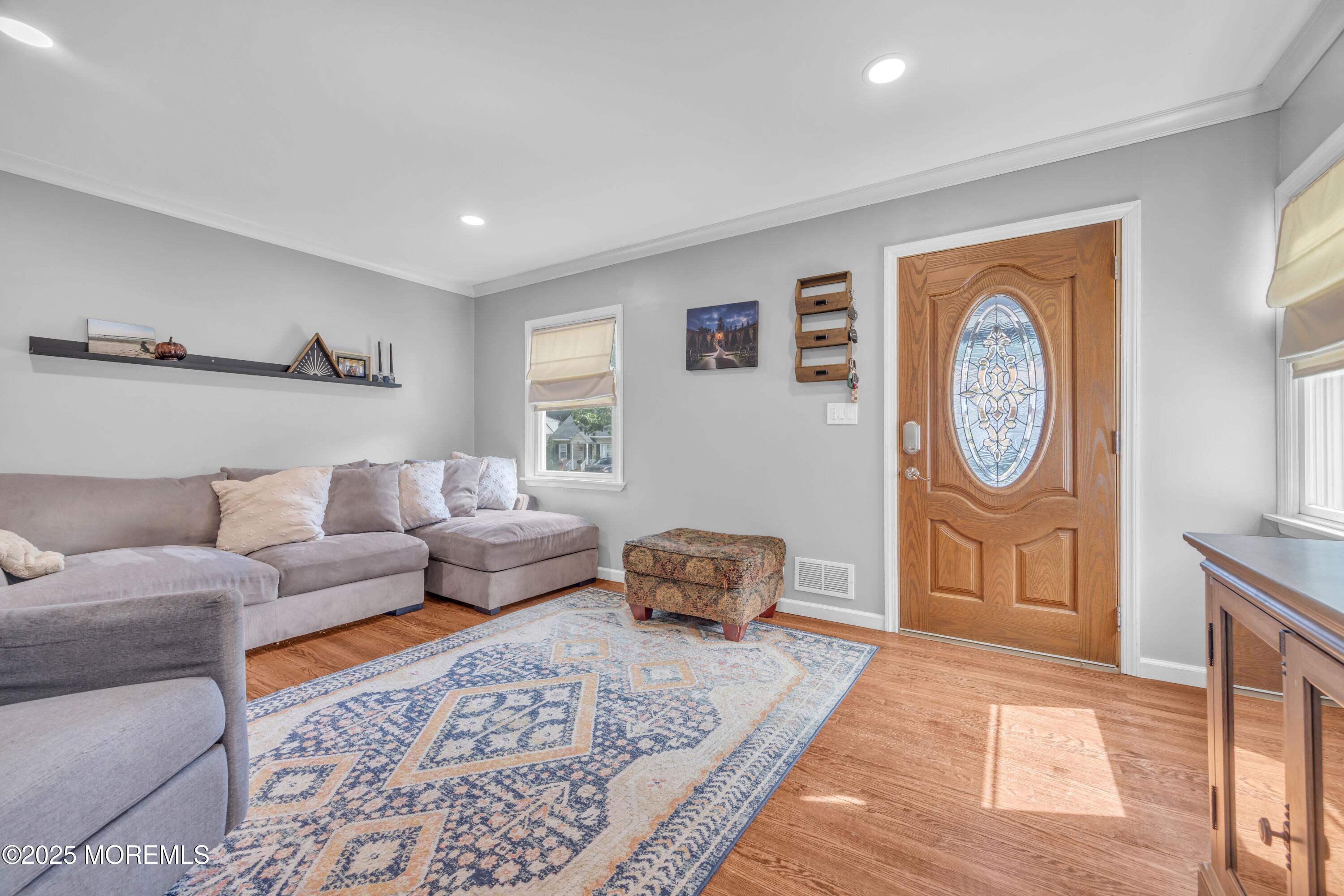 75 Ridgewood Road Clifton, NJ 07012 - Photo 5 of 41 a living room with furniture a clock and a rug