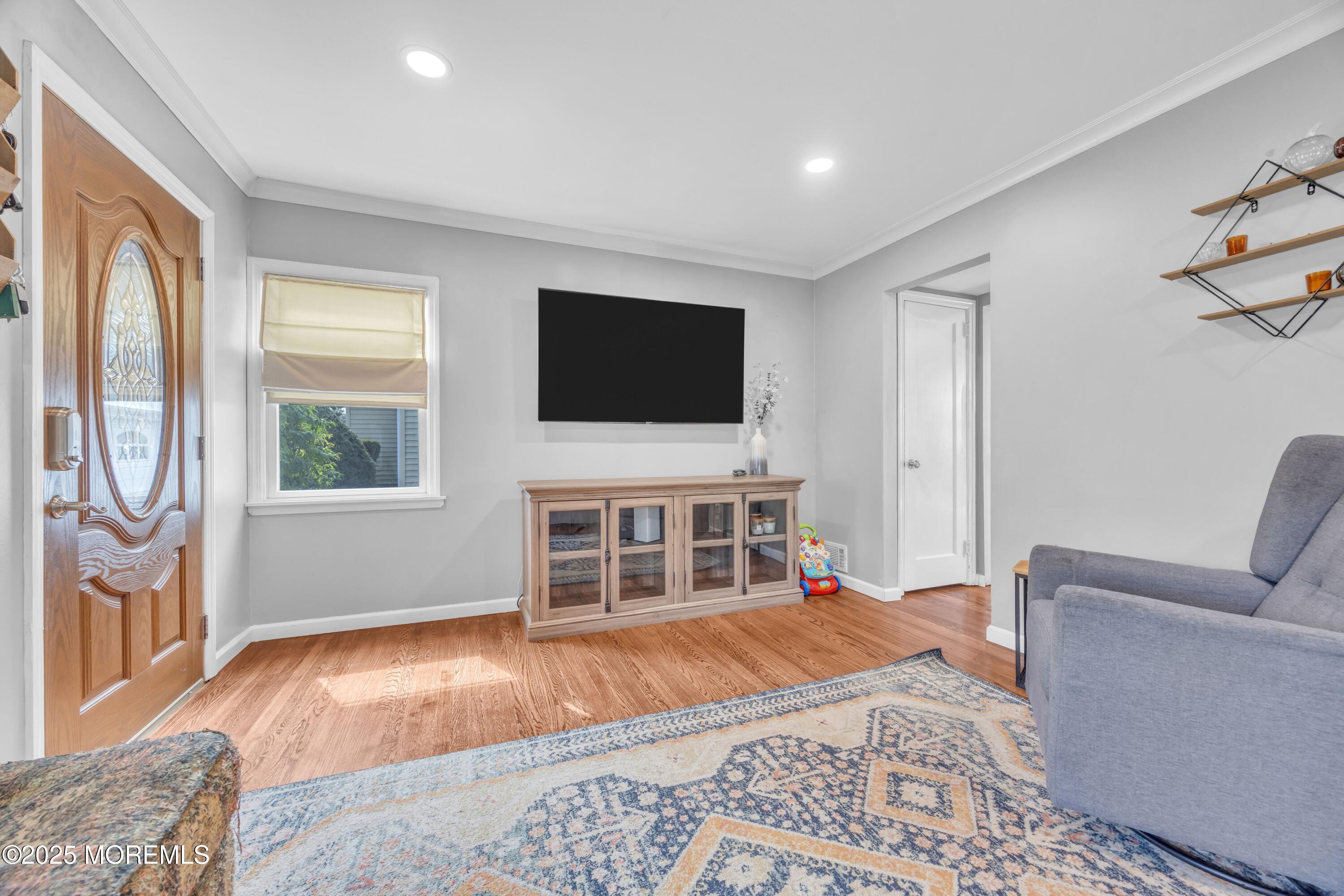 75 Ridgewood Road Clifton, NJ 07012 - Photo 7 of 41 a living room with a bed furniture and a flat screen tv