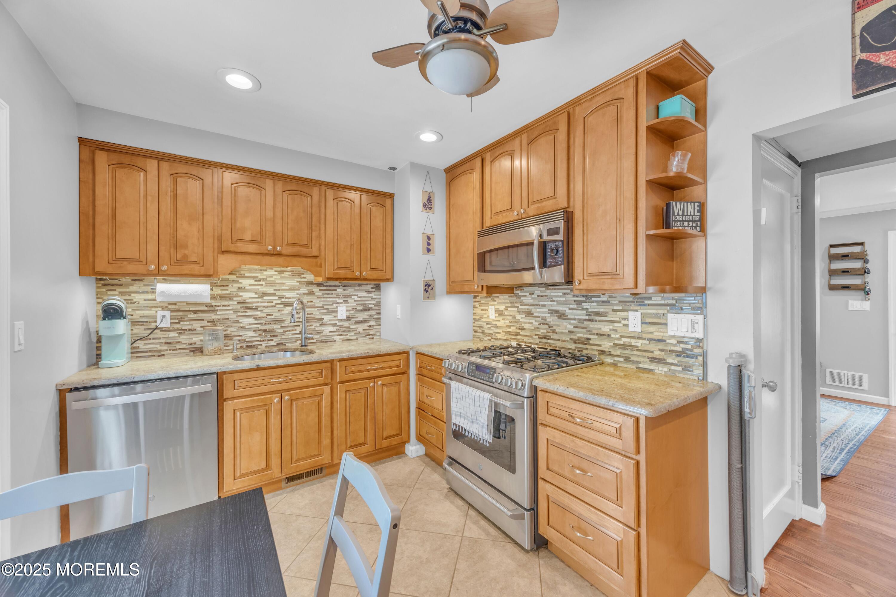 75 Ridgewood Road Clifton, NJ 07012 - Photo 9 of 41 a kitchen with stainless steel appliances granite countertop a sink and cabinets