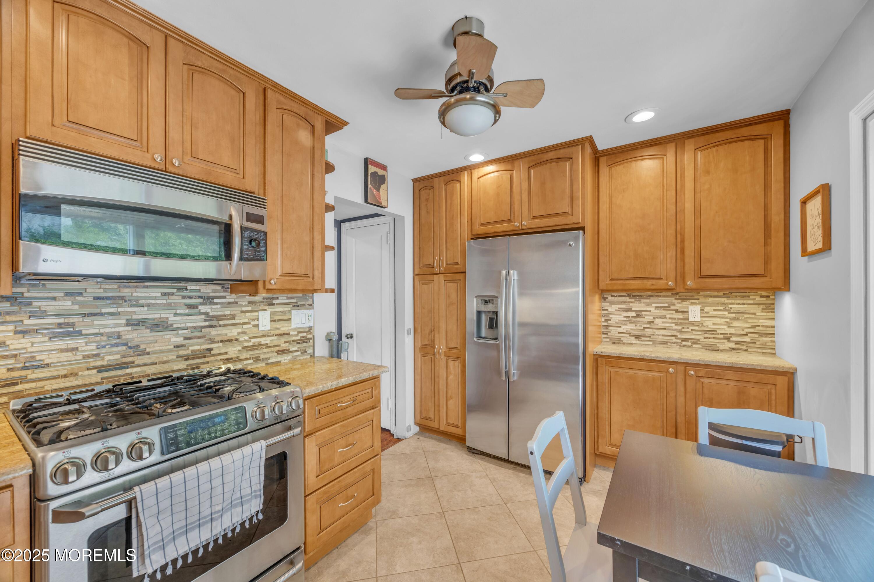 75 Ridgewood Road Clifton, NJ 07012 - Photo 10 of 41 a kitchen with stainless steel appliances granite countertop a stove a refrigerator and a refrigerator