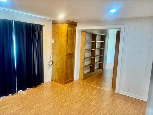 a bedroom with a bed and wooden closet