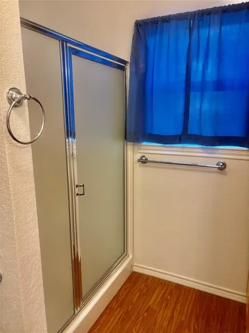 a bathroom with a granite countertop shower and a sink