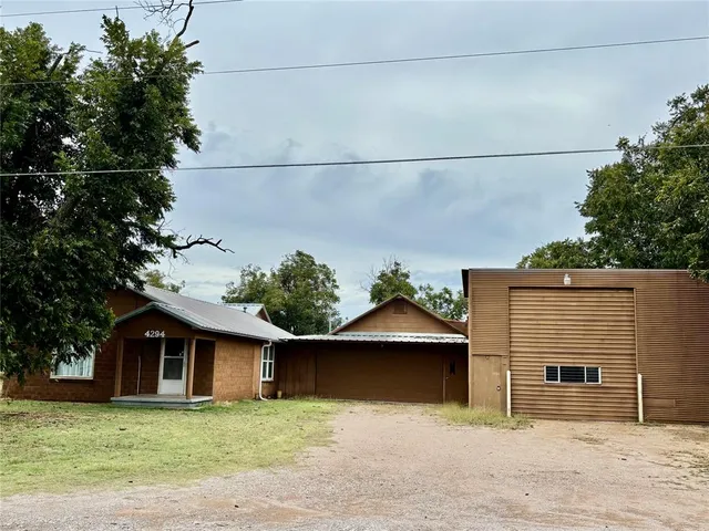 a front view of a house with plants