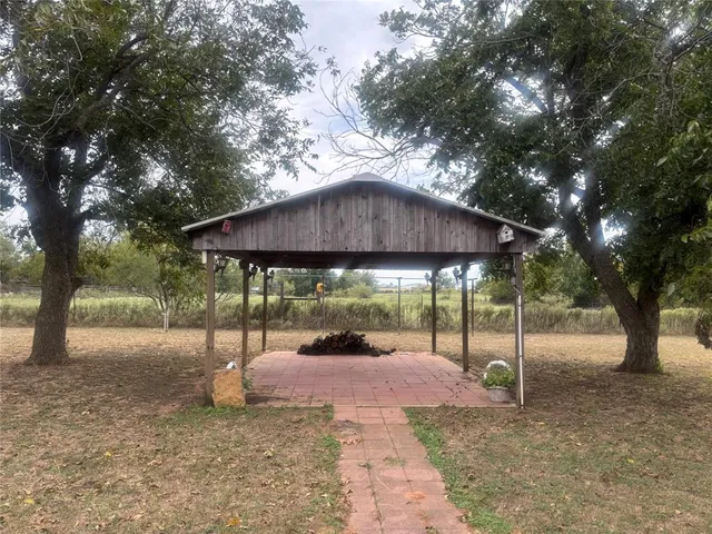 a backyard of a house with table and chairs