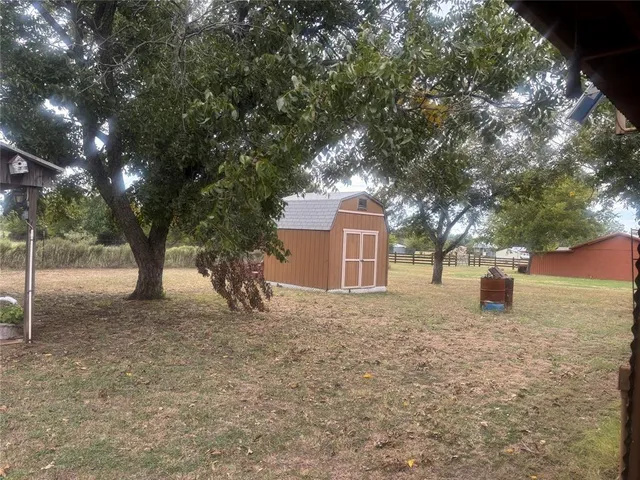 a tree in front of a white house