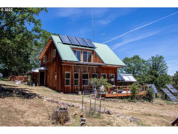 a view of a chairs and tables in the back yard of the house