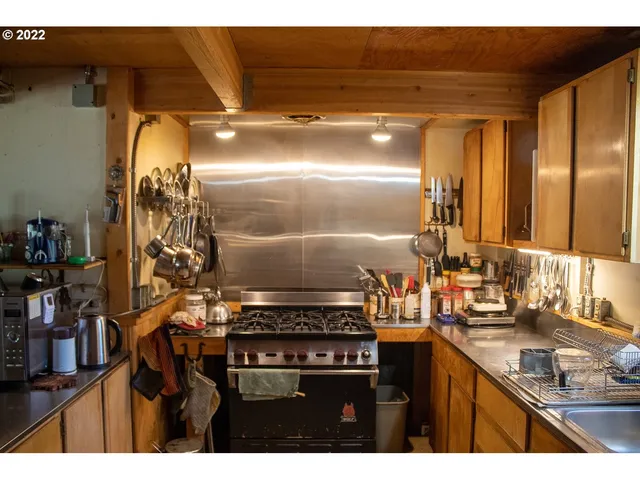 a dining room with furniture a chandelier and wooden floor