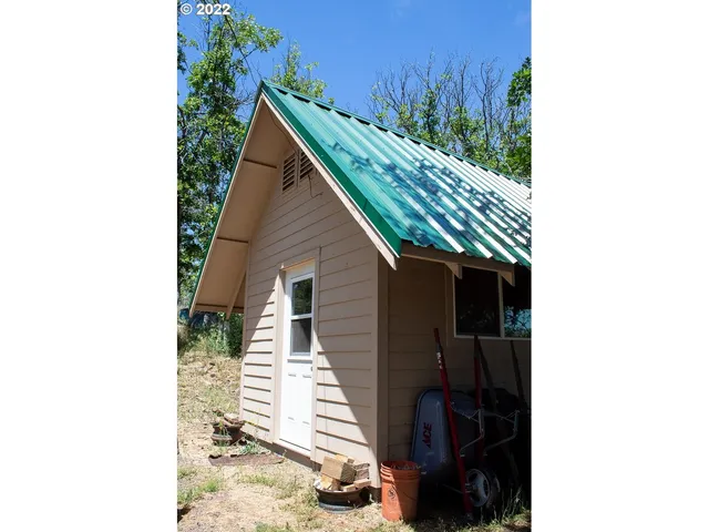 a view of a house with a yard and sitting area
