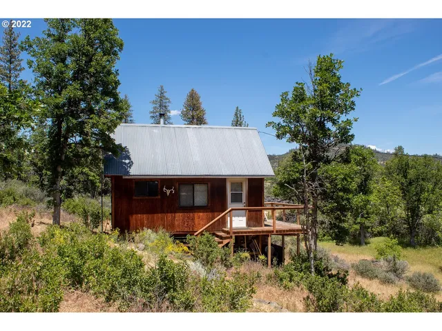 a view of a house with a yard patio and furniture