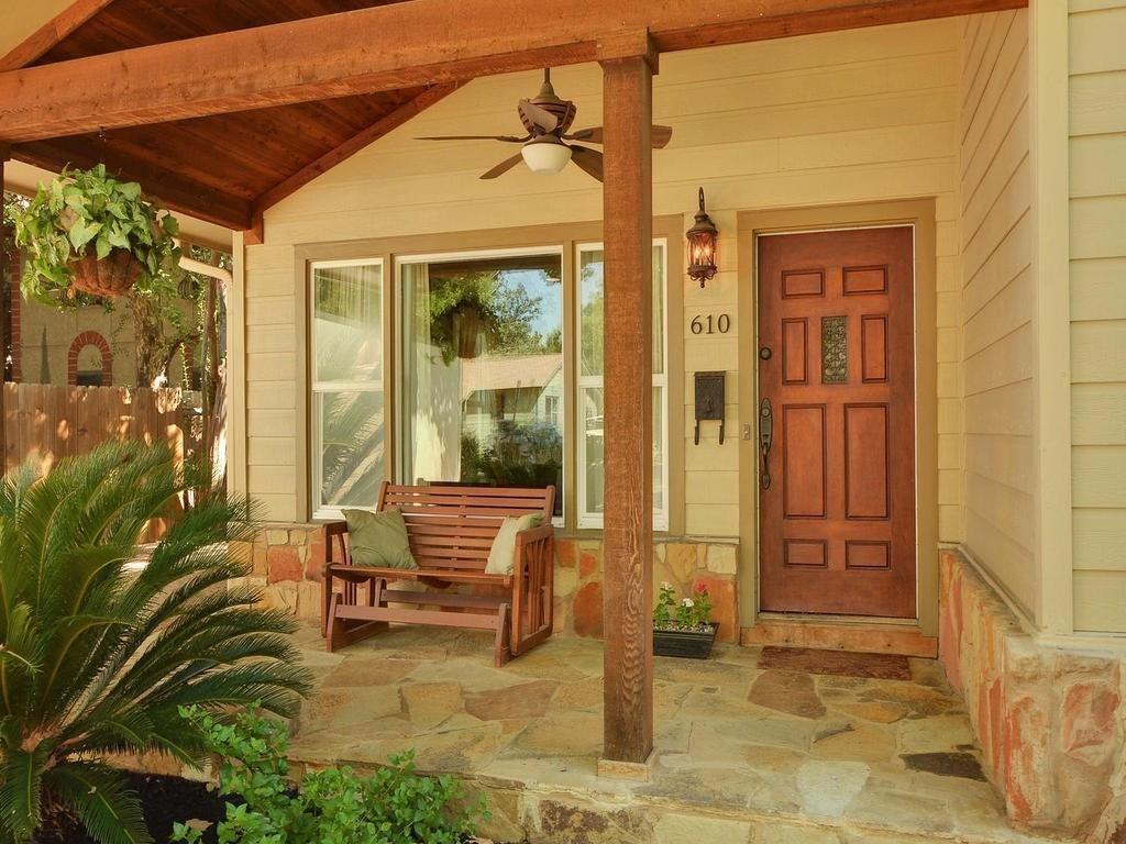 610 West N Loop Boulevard Austin, TX 78751 - Photo 7 of 29 Inviting front porch featuring a wooden ceiling, a ceiling fan, and flagstone flooring
