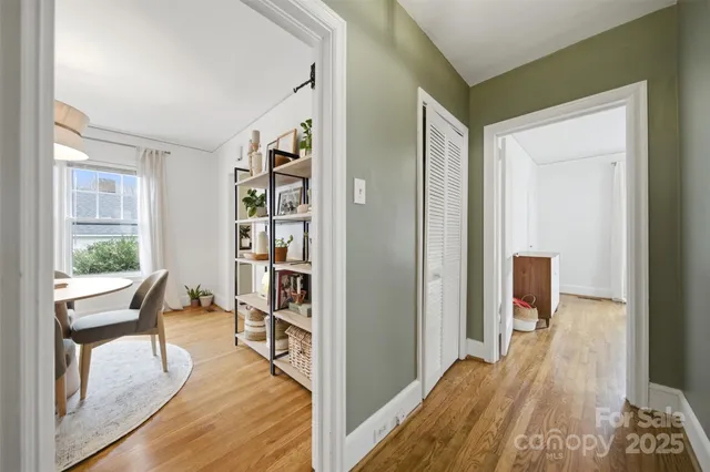 a view of a bedroom with wooden floor and furniture