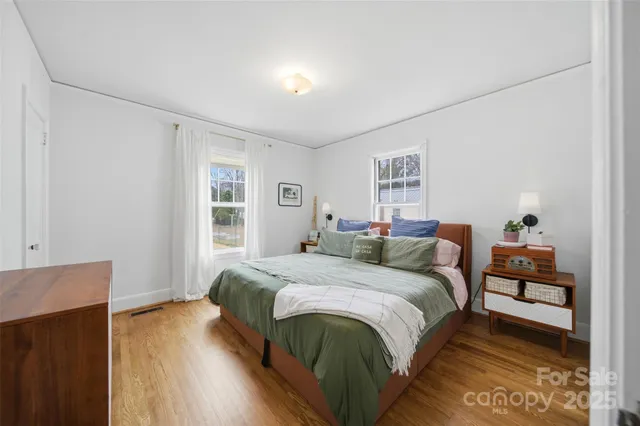 a bedroom with a bed and a night stand