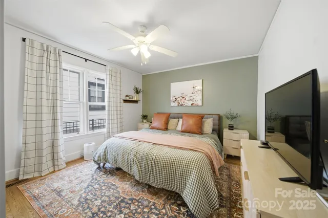 a bedroom with a large bed and a flat screen tv
