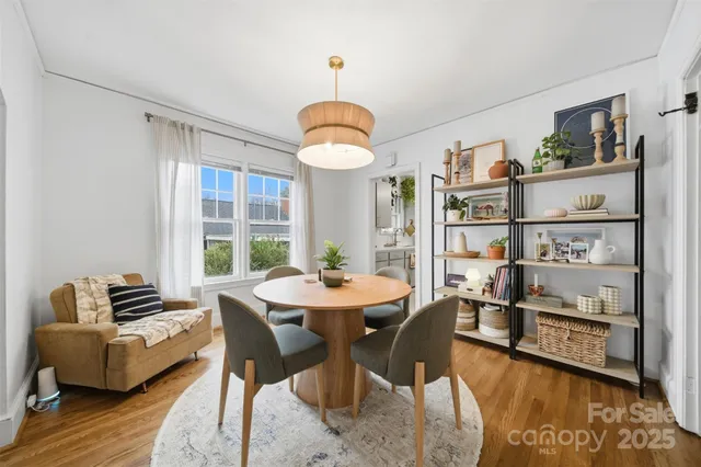 a view of a dining room with furniture window and wooden floor