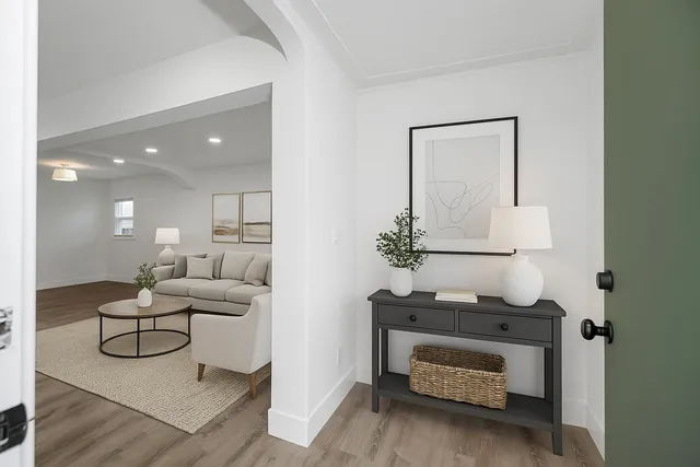 a living room with furniture and a wooden floor