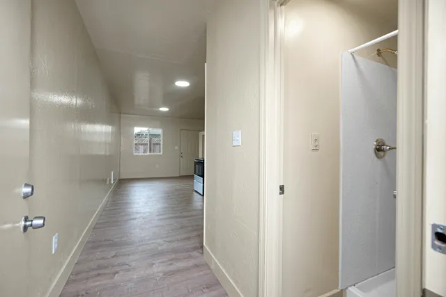 a view of hallway with wooden floor