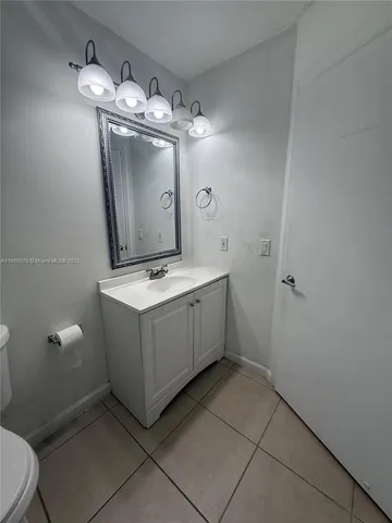 a bathroom with a sink a toilet and mirror
