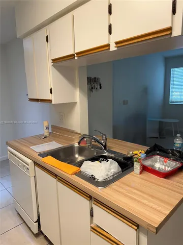 a kitchen that has a sink and a stove