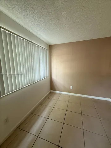 a view of an empty room and a window