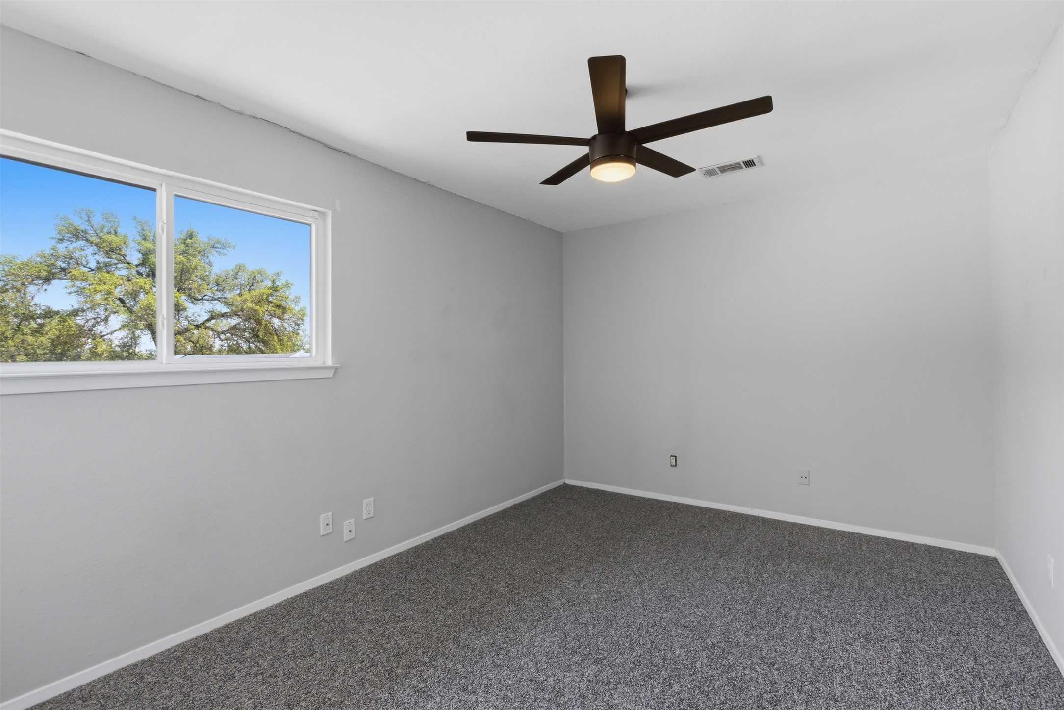 4204 Hudson Bend Road, Unit B Austin, TX 78734 - Photo 22 of 37 Bright room featuring gray walls and gray carpeting
