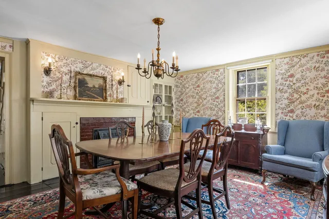 a view of a dining room with furniture wooden floor and a chandelier