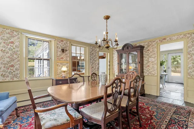 a view of a dining room with furniture and window