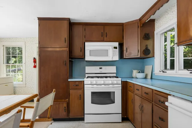a kitchen with stainless steel appliances granite countertop a stove a microwave and a refrigerator