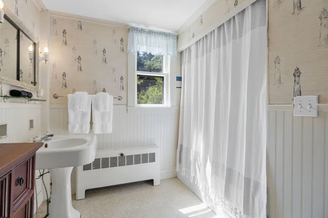 a bathroom with a sink a mirror and a shower