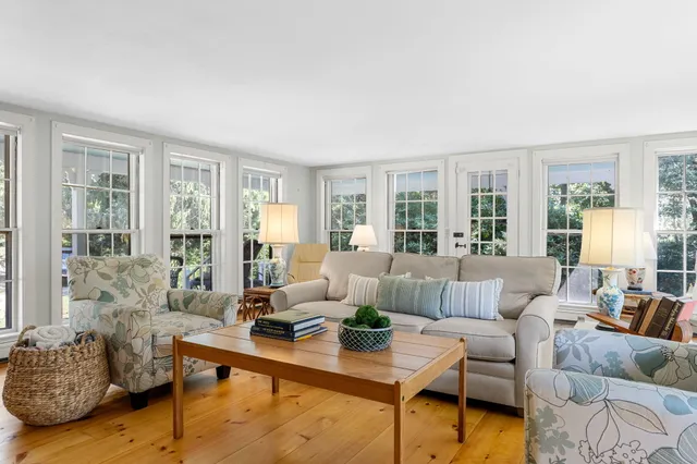 a living room with furniture and floor to ceiling windows