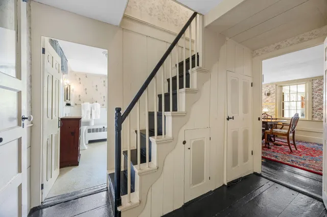 a view of entryway with dining room and wooden floor