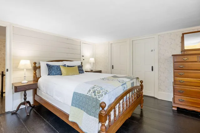 a bedroom with a bed and a night stand