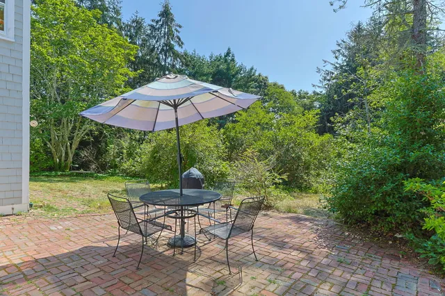 a view of backyard with seating space and trees