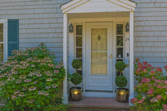 front view of a house with a potted plant