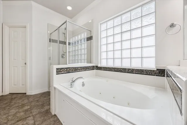 a bathroom with a bathtub and a shower