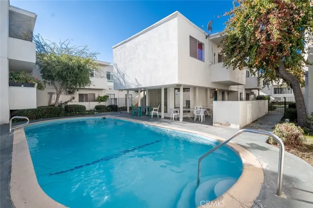 a view of a house with pool and sitting area