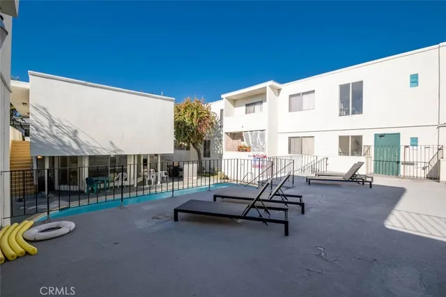 a view of a patio with a table and chairs