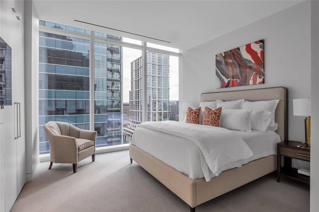 1747 Leonard Street, Unit 1402 Dallas, TX 75201 - Photo 22 of 36 a bedroom with a bed and glass window
