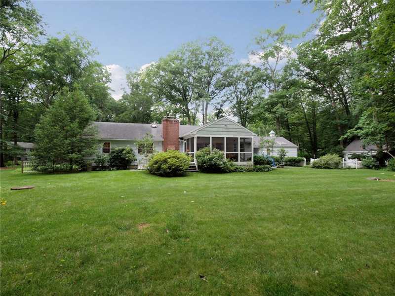 2 Shady Acres Road Darien, CT 06820 - Photo 3 of 18 a front view of a house with a yard and trees